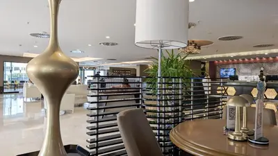 a gold vase sitting on a table in a restaurant at Istanbul Gonen Hotel in Istanbul