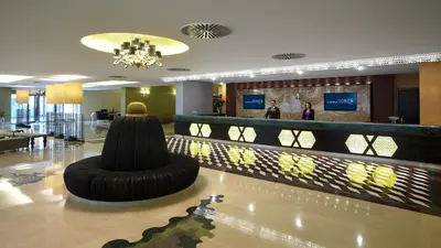a hotel lobby with a bar with a couch in the middle at Istanbul Gonen Hotel in Istanbul
