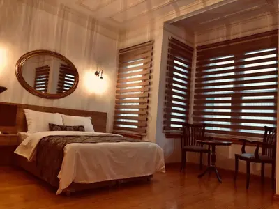 a bedroom with a bed and a desk and a mirror at Belizia Hotel in Istanbul