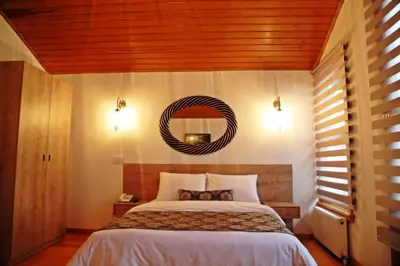 a bedroom with a bed and a mirror on the wall at Belizia Hotel in Istanbul