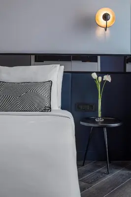 a bedroom with a bed and a table with a vase of flowers at The Westist Hotel & Spa - Special Category in Istanbul