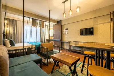 a living room with a couch and a bedroom at Cube Suites in Istanbul