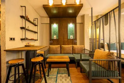 a living room with a couch and a bar at Cube Suites in Istanbul