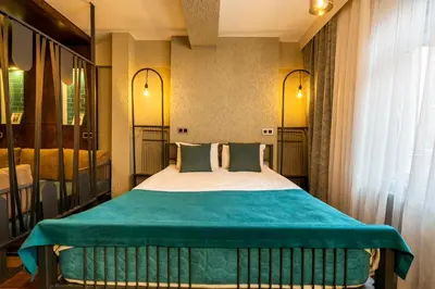 a bedroom with a large bed with blue sheets at Cube Suites in Istanbul
