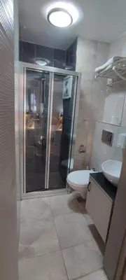 a bathroom with a shower and a toilet and a sink at Ortaköy Suites Hotel in Istanbul