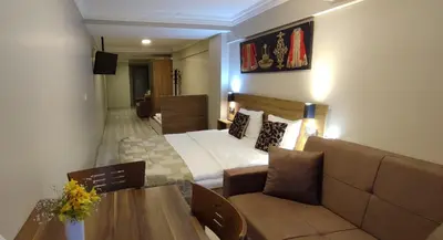 a hotel room with a bed and a couch at Ortaköy Suites Hotel in Istanbul