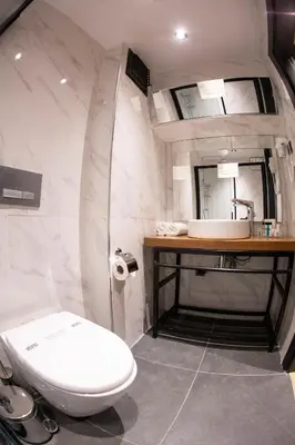 a bathroom with a toilet and a sink at Meydan Besiktas Hotel in Istanbul