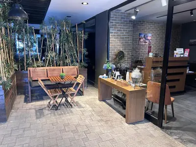 a dining room with a table and chairs and plants at Meydan Besiktas Hotel in Istanbul