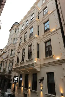 a large white building with windows on a street at Ferman Pera Hotel in Istanbul