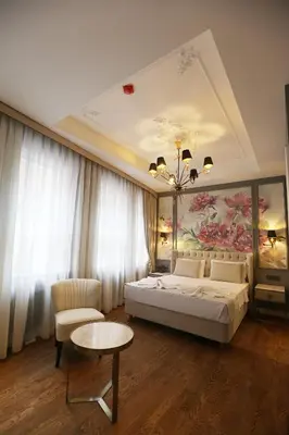 a bedroom with a bed and a painting on the ceiling at Royal Tophane in Istanbul