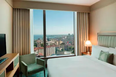 a hotel room with a bed and a large window at Renaissance Istanbul Polat Bosphorus Hotel in Istanbul
