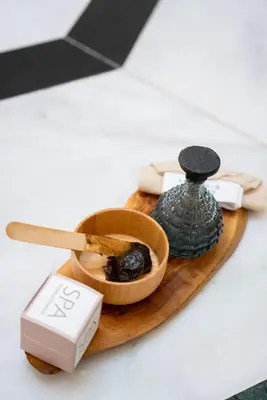 a wooden cutting board with a bottle and a bowl of food at InterContinental Istanbul by IHG in Istanbul