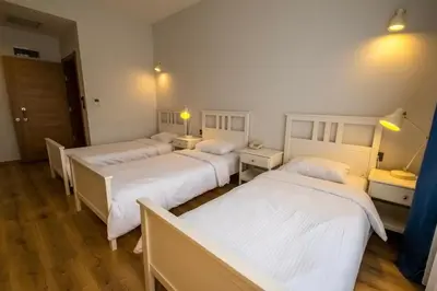 a group of four beds in a room at Eleia Hotel İznik in Bursa