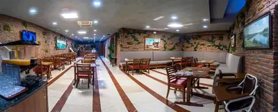 a restaurant with tables and chairs and a brick wall at Aprilis Hotel - Special Category in Istanbul