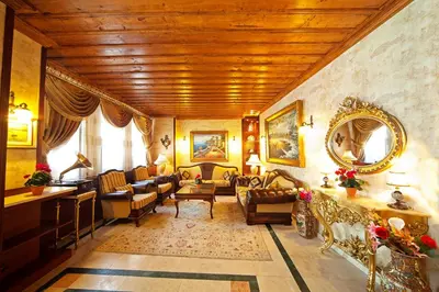 a living room filled with furniture and a wooden ceiling at Dilhayat Kalfa Hotel in Istanbul