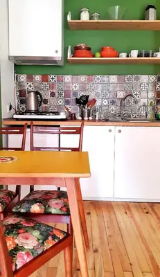 a kitchen with white cabinets and a wooden table at Kunterbunt Istanbul in Istanbul