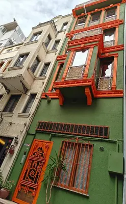 a green and orange building with orange windows at Kunterbunt Istanbul in Istanbul