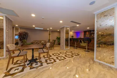 a living room with a table and chairs and a couch at Vision Deluxe Hotel in Istanbul