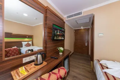 a hotel room with a bed and a mirror at Vision Deluxe Hotel in Istanbul