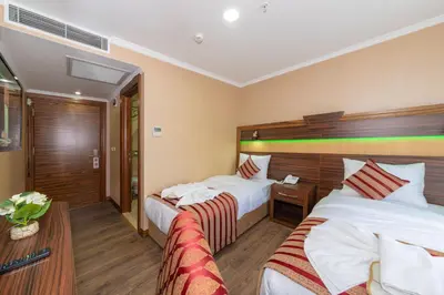 a hotel room with two beds and a table at Vision Deluxe Hotel in Istanbul