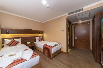 a hotel room with two beds and a balcony at Vision Deluxe Hotel in Istanbul