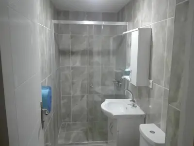 a bathroom with a toilet and a sink and a shower at NEW BEYLERBEYİ HOTEL in Istanbul