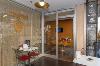 a restaurant with a table and chairs in front of a window at Regno Hotel in Istanbul