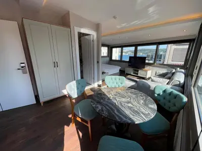 a living room with a table and chairs and a couch at Feri Suites in Istanbul