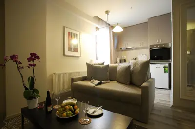 a living room with a couch and a table with a bowl of fruit at Home Stay Home Sisli in Istanbul