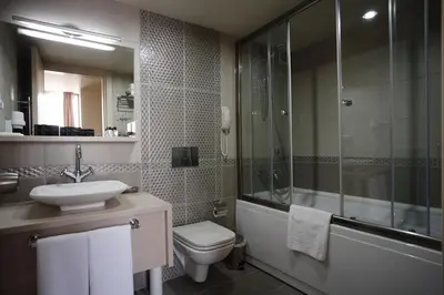 a bathroom with a toilet and a sink and a shower at Home Stay Home Sisli in Istanbul