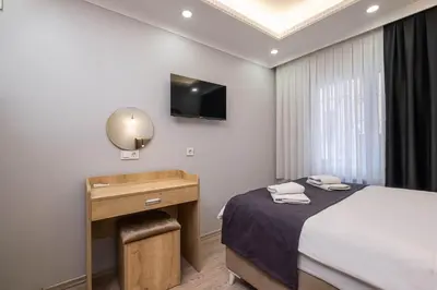 a bedroom with a bed and a desk and a television at Family Istanbul Hotel in Istanbul
