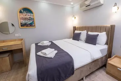 a bedroom with a bed with two towels on it at Family Istanbul Hotel in Istanbul