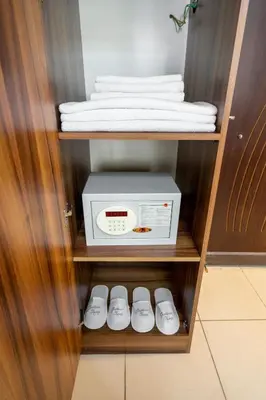 a small cabinet with a microwave and some towels at Pi Home & Apartments in Istanbul