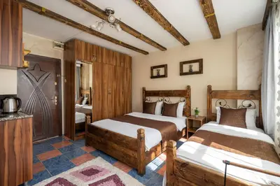 a bedroom with two beds and a bathroom at Pi Home & Apartments in Istanbul