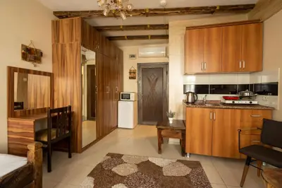 a kitchen with wooden cabinets and a table in a room at Pi Home & Apartments in Istanbul