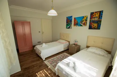 a bedroom with two beds and a pink door at The Doctor's House in Sapanca