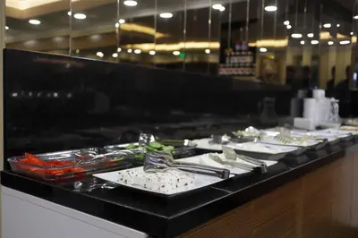a buffet line with plates of food in a restaurant at NL Amsterdam Hotel in Istanbul