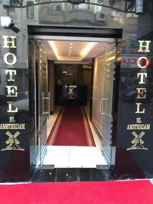 an entrance to a building with a red carpet at NL Amsterdam Hotel in Istanbul