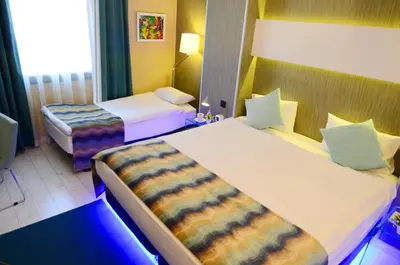 a hotel room with two beds and a window at Tempo Hotel 4Levent in Istanbul