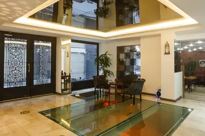 a living room with a glass table and chairs at P Galata Hotel - Special Category in Istanbul