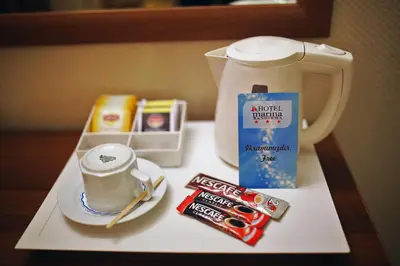 a tray with a cup of coffee and other items on it at Hotel Villa Marina in Bandırma