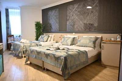 a bedroom with two beds with blue and white sheets at Elite Marmara Hotel Gungoren in Istanbul