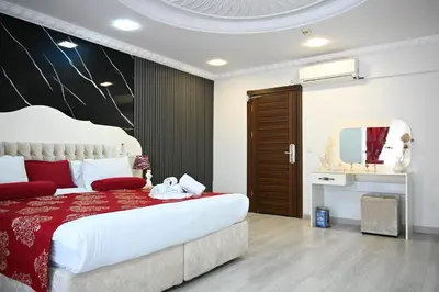 a bedroom with a large bed and a mirror at Elite Marmara Hotel Gungoren in Istanbul
