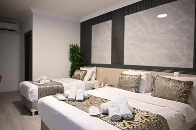 a hotel room with two beds with towels on them at Elite Marmara Hotel Gungoren in Istanbul