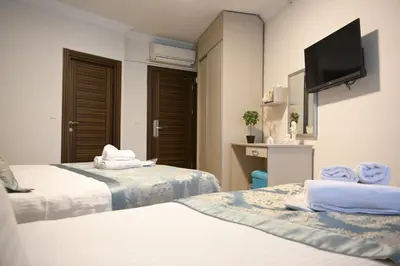 a hotel room with two beds and a flat screen tv at Elite Marmara Hotel Gungoren in Istanbul