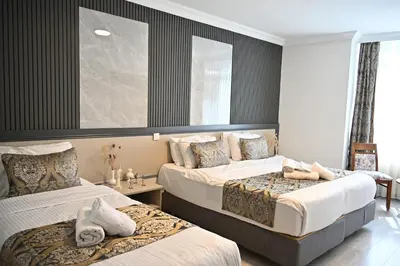 a hotel room with two beds and a mirror at Elite Marmara Hotel Gungoren in Istanbul