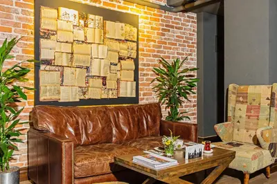 a living room with a leather couch and a table at Meroddi Galata Mansion in Istanbul