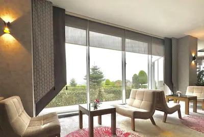a living room with chairs and a large window at Ramada by Wyndham Tekirdağ in Tekirdag
