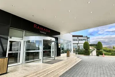 a building with a glass entrance to a building at Ramada by Wyndham Tekirdağ in Tekirdag