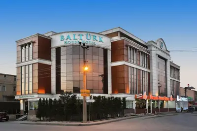 a building with a sign on the front of it at Balturk House Hotel in Kocaeli